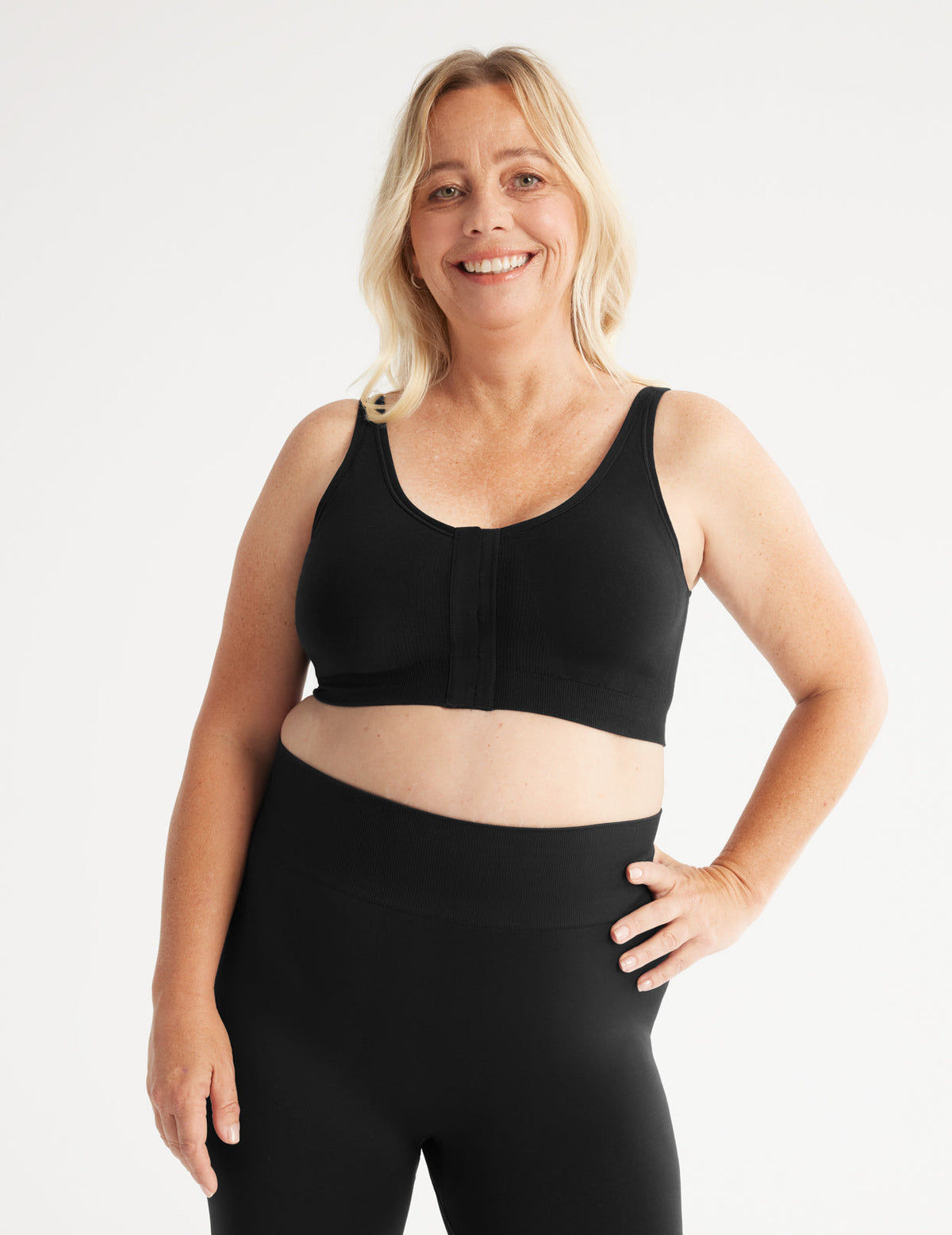 Full-body view of model wearing the Ultra Soft Front Closure Bra, highlighting the neckline, easy front closure, and seamless knit silhouette – Black – view 5 of 13