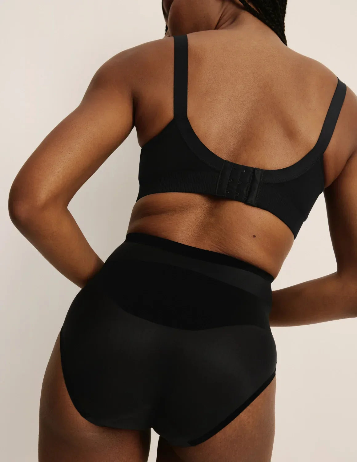 Back view of model wearing the BlissFit™ Nursing Bra, highlighting the neckline, nursing clip strap design, and smooth silhouette – Black – view 7 of 15