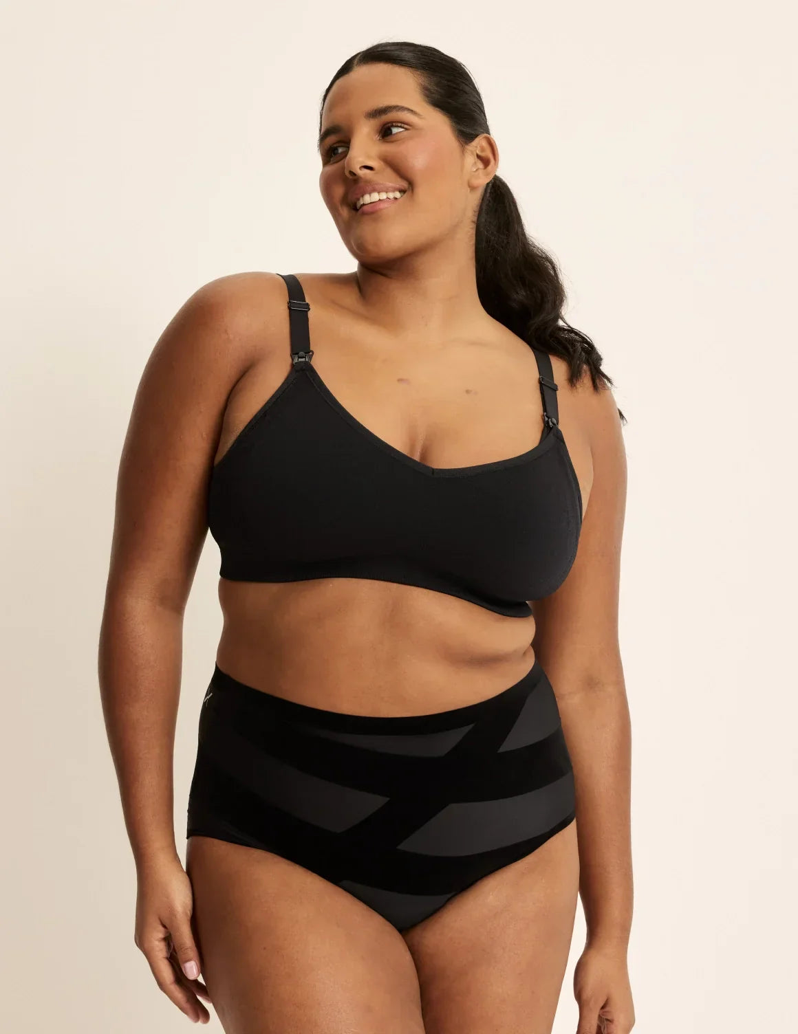 Full-body view of model wearing the BlissFit™ Nursing/Pumping Bra, highlighting the neckline, nursing clip strap design, and smooth silhouette – Black – view 7 of 13