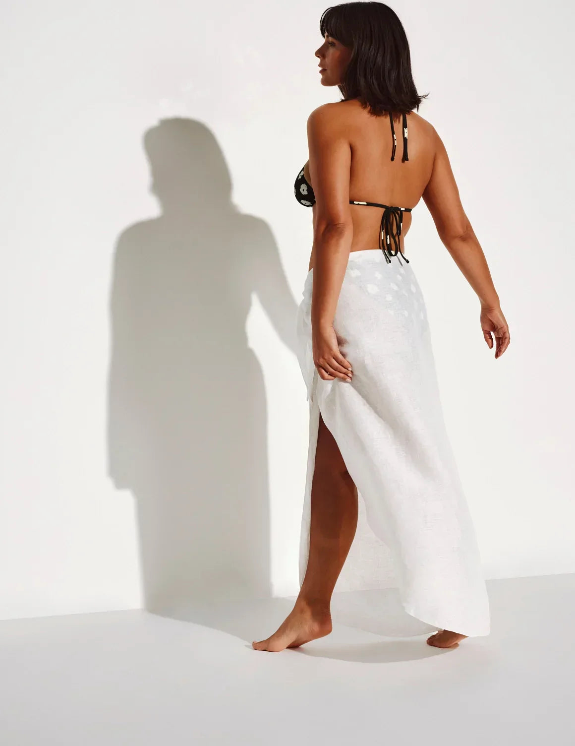 Back view of model wearing the Crinkle Linen Sarong highlighting the coverage and fit – Ivory – view 7 of 13