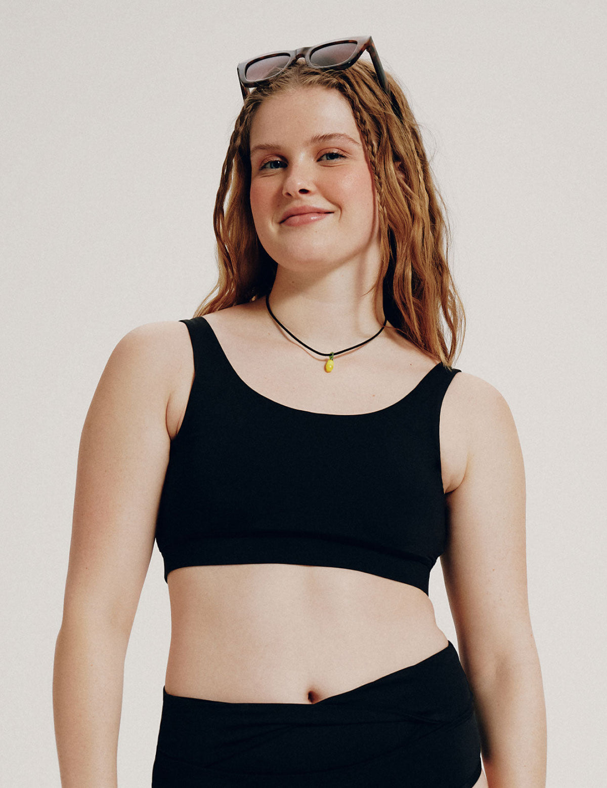Front view of model wearing the Teen Double Scoop Bikini Top highlighting the neckline, strap design, and silhouette – Black – view 1 of 62