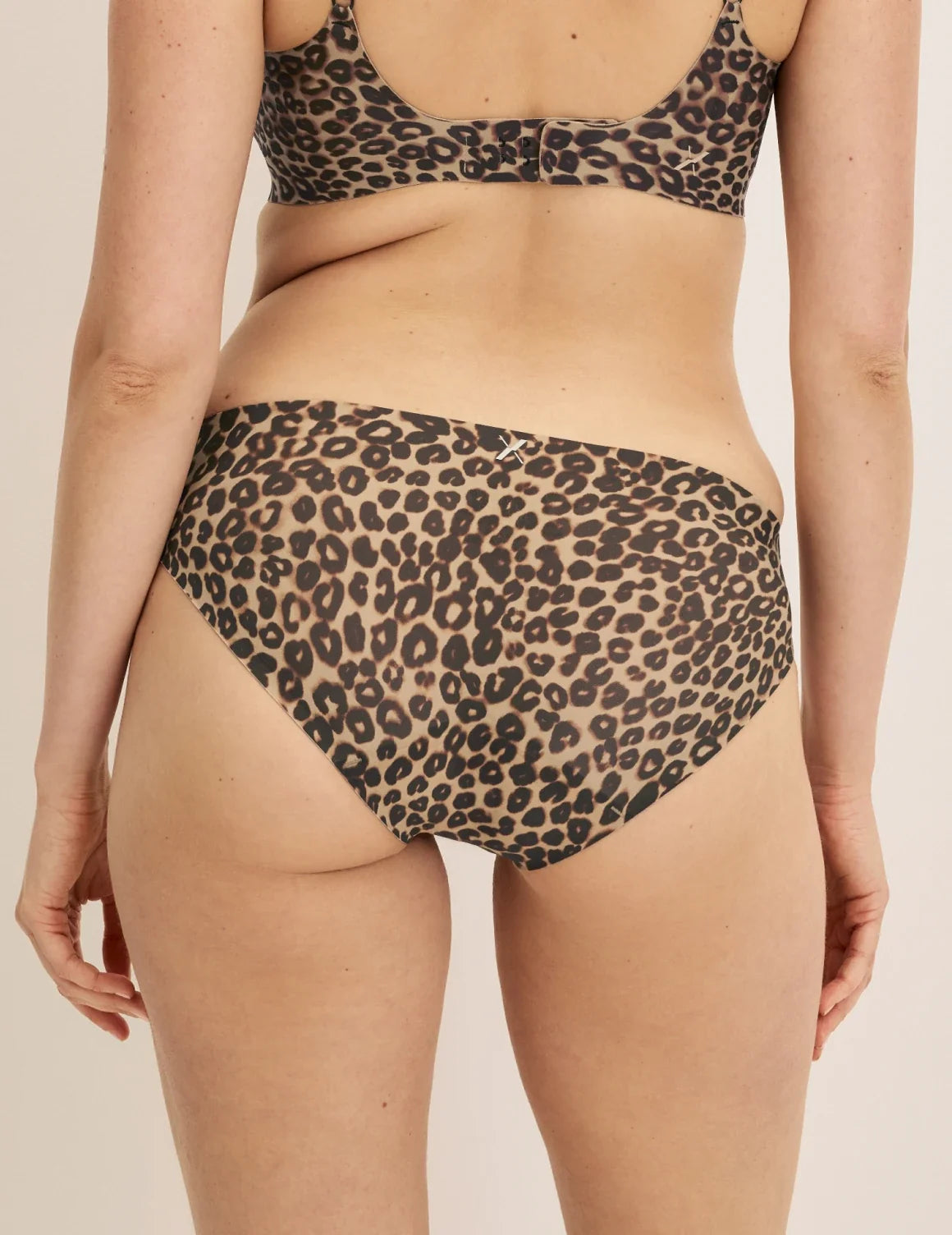 Back view of model wearing the Essential No-Show Bikini highlighting the coverage and smooth fit – Cheetah Print – view 3 of 31