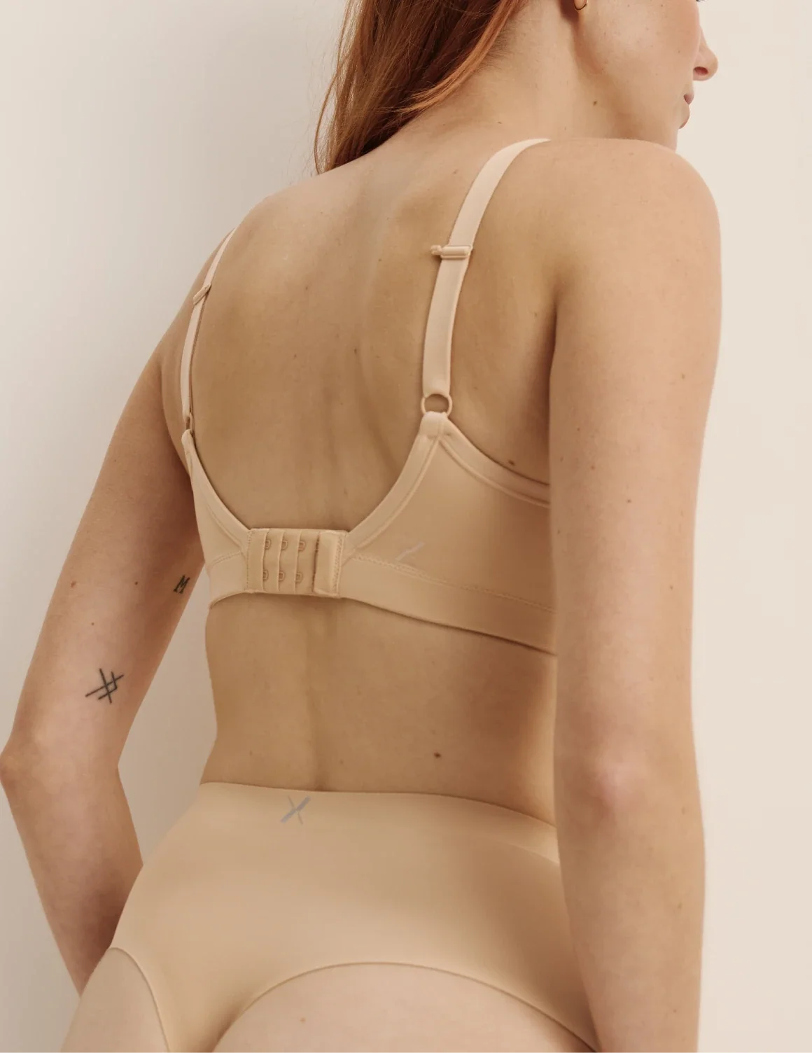 Back view of model wearing the Essential No-Show High Rise Thong highlighting the coverage and smooth fit – Warm Sand – view 7 of 8