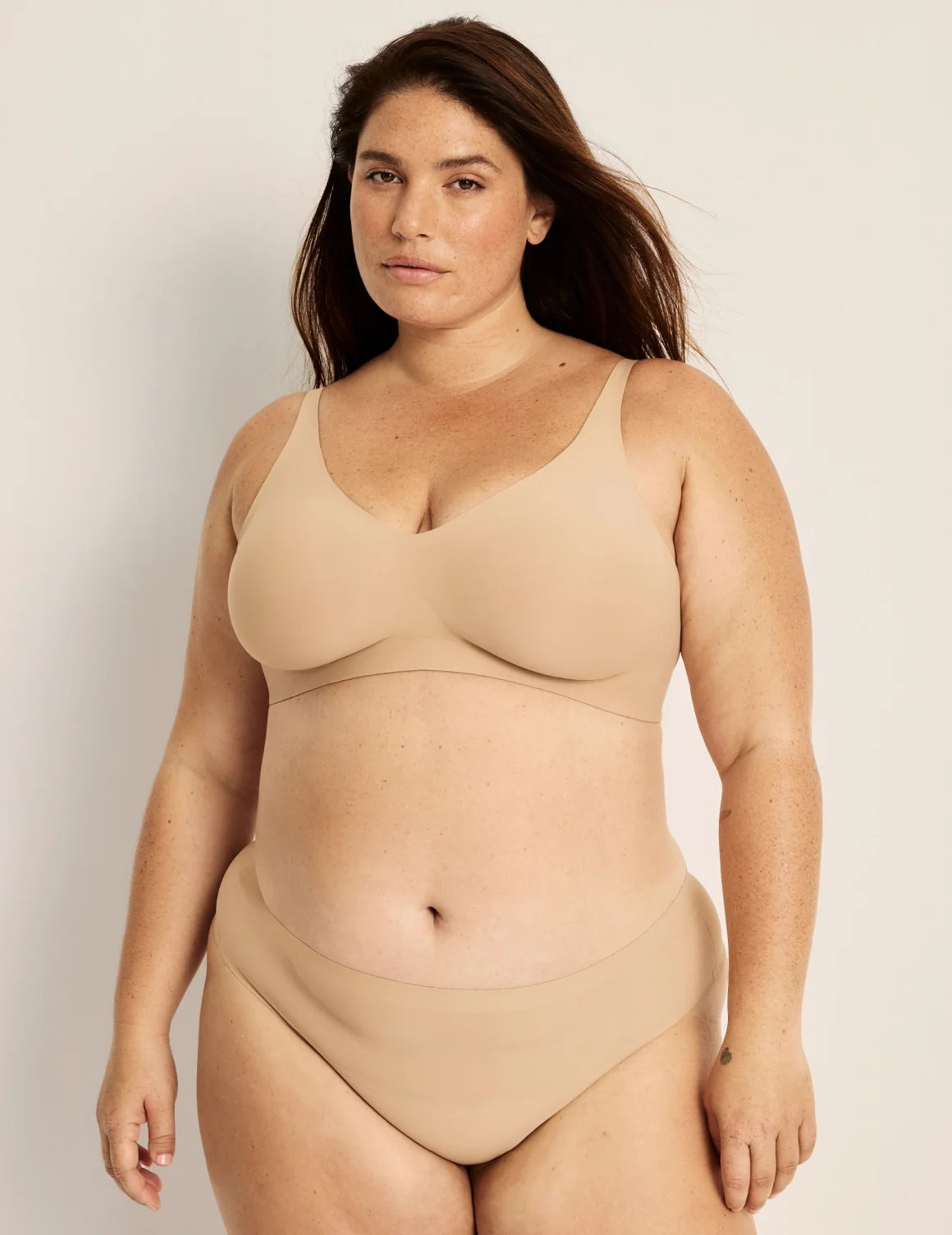 Front view of model wearing the Essential No-Show Thong highlighting the coverage and smooth fit – Nude Multi – view 3 of 18