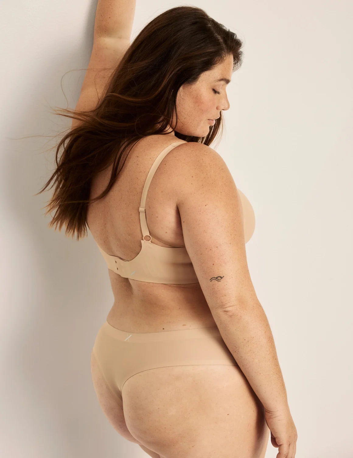 Side view of model wearing the Essential No-Show Thong highlighting the coverage and smooth fit – Nude Multi – view 4 of 18