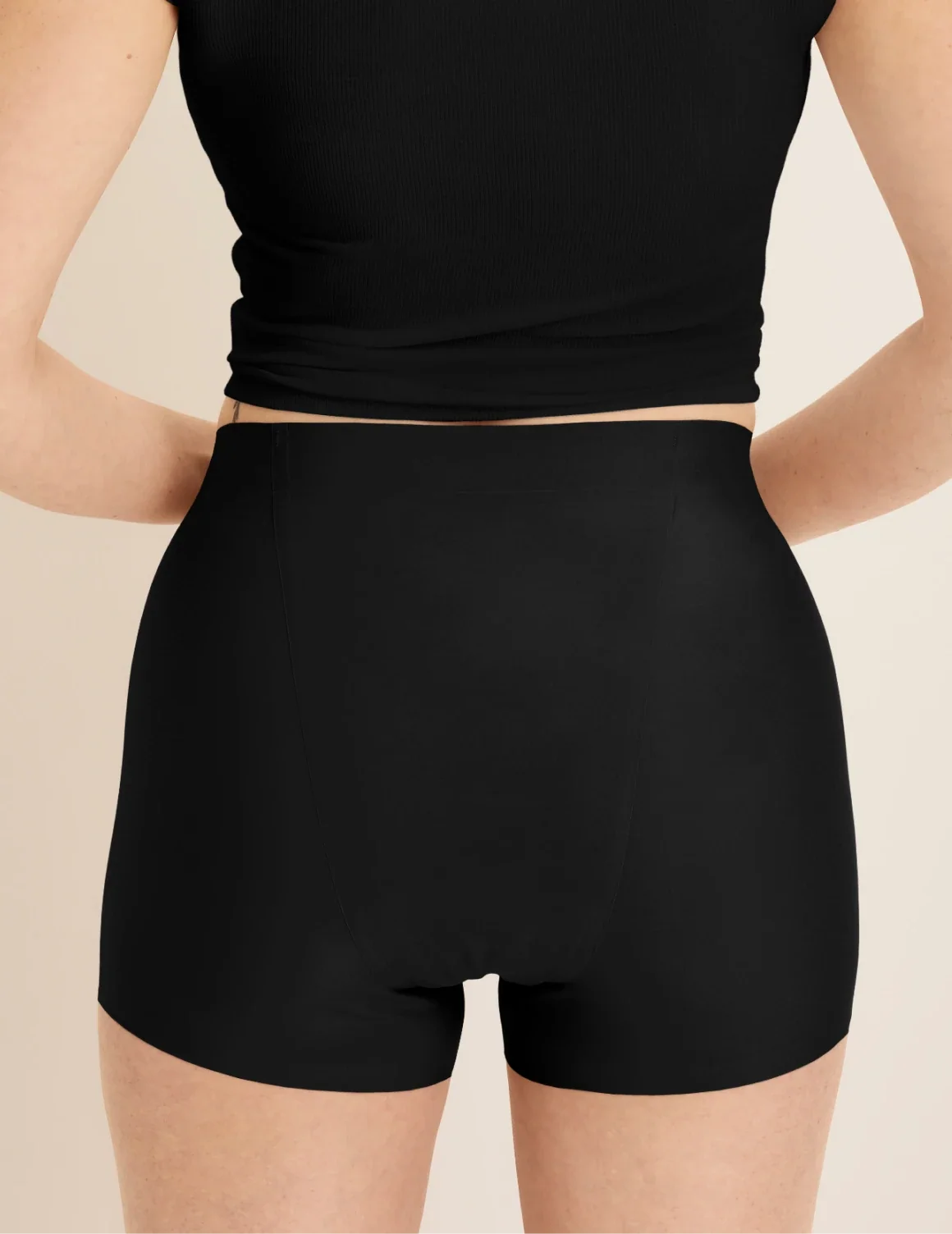 Back view of model wearing the SuperPlus Leakproof® Dream Short highlighting the coverage and smooth fit – Black – view 4 of 36