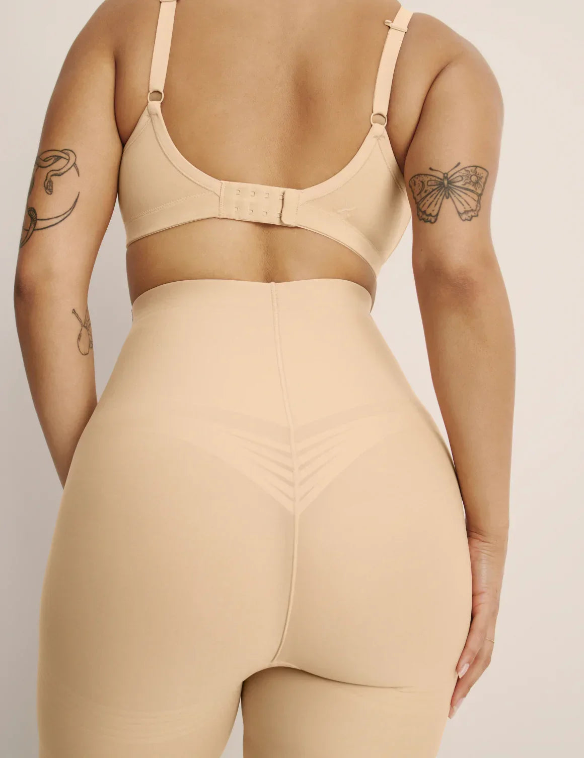 Back view of model wearing the Customizable Shaper High Rise Shorts, highlighting the coverage and smooth fit – Warm Sand – view 9 of 15