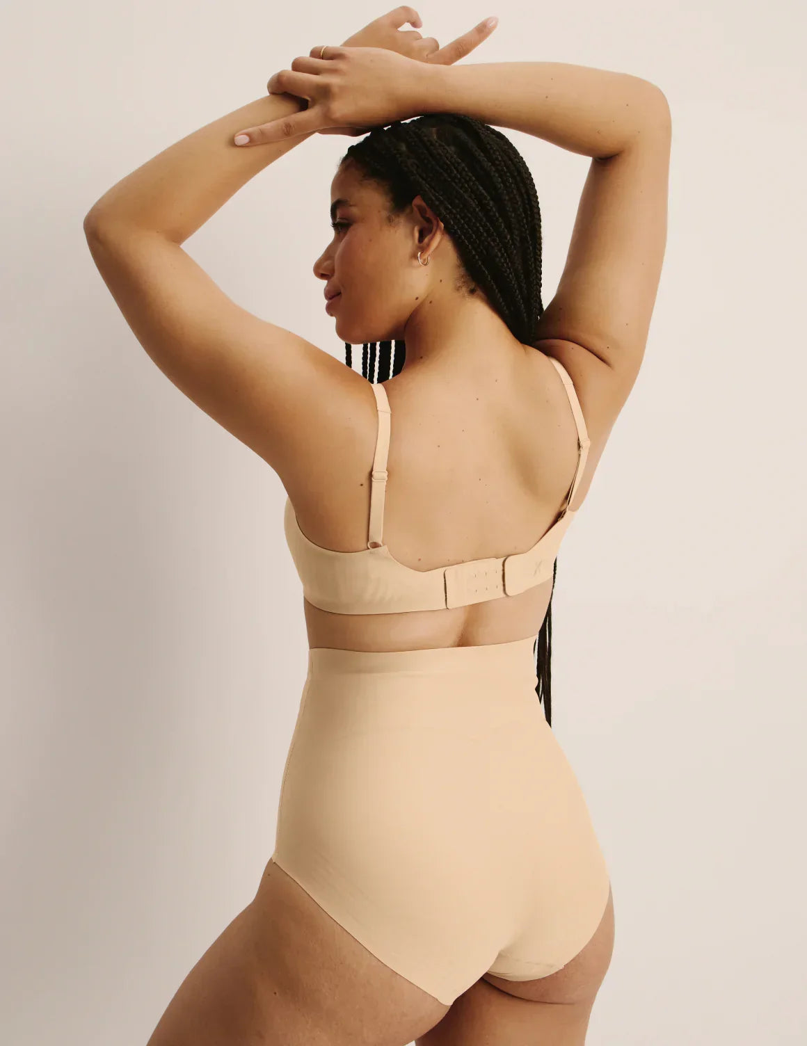 Back view of model wearing the Shaper High Rise Briefs, highlighting the coverage and smooth fit – Warm Sand – view 9 of 12