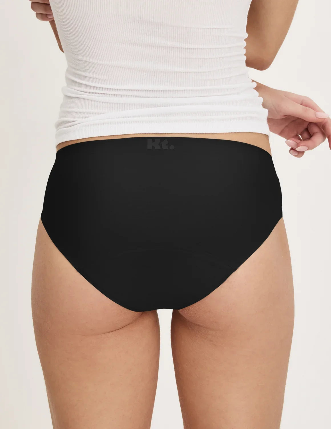 Back view of model wearing the Teen Super Leakproof® No-Show Bikini highlighting the coverage and smooth fit – Black – view 4 of 29