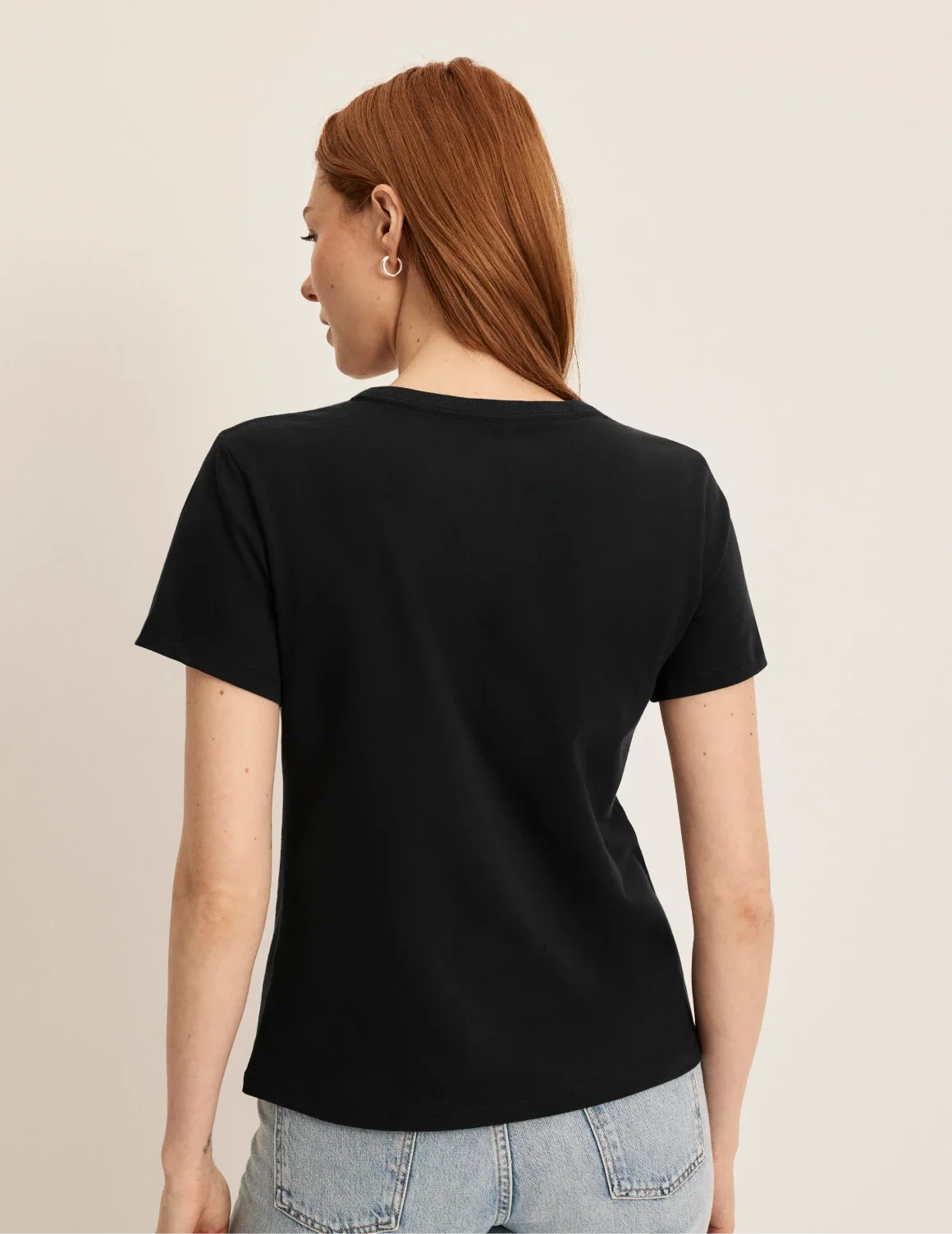 Back view of model wearing the Cotton Relaxed T-Shirt highlighting the coverage and fit – Black – view 8 of 20
