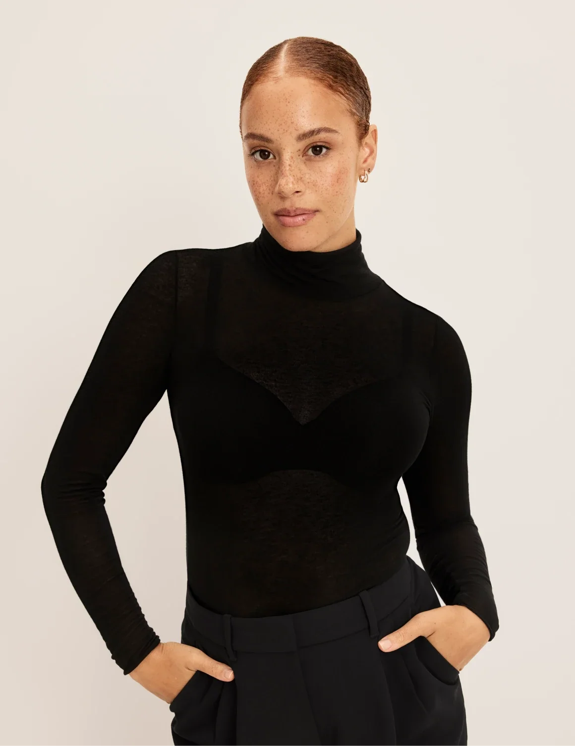 Front view of model wearing the Cashmere Mist Turtleneck highlighting the neckline and fit – Black – view 1 of 9