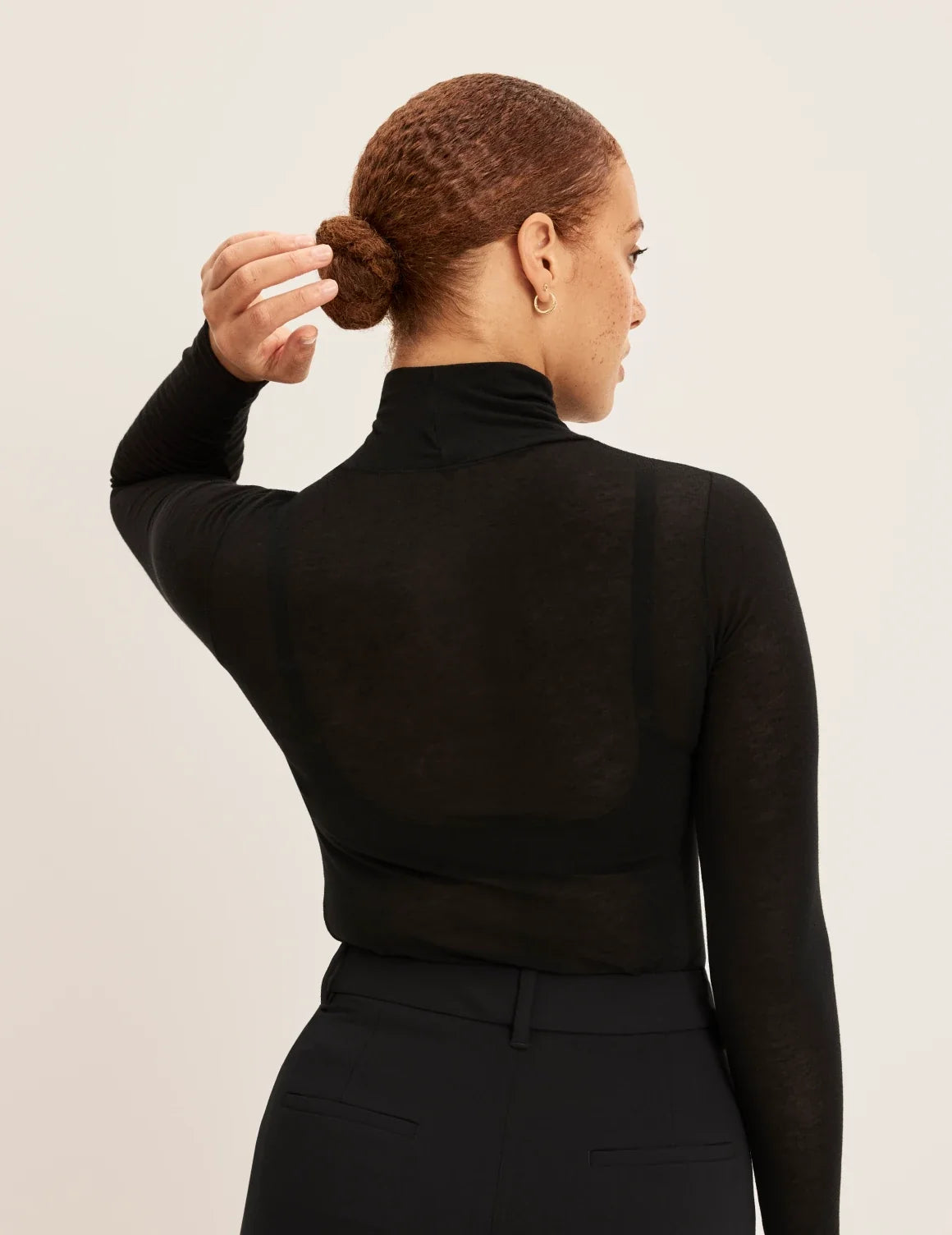 Back view of model wearing the Cashmere Mist Turtleneck highlighting the neckline and fit – Black – view 5 of 9