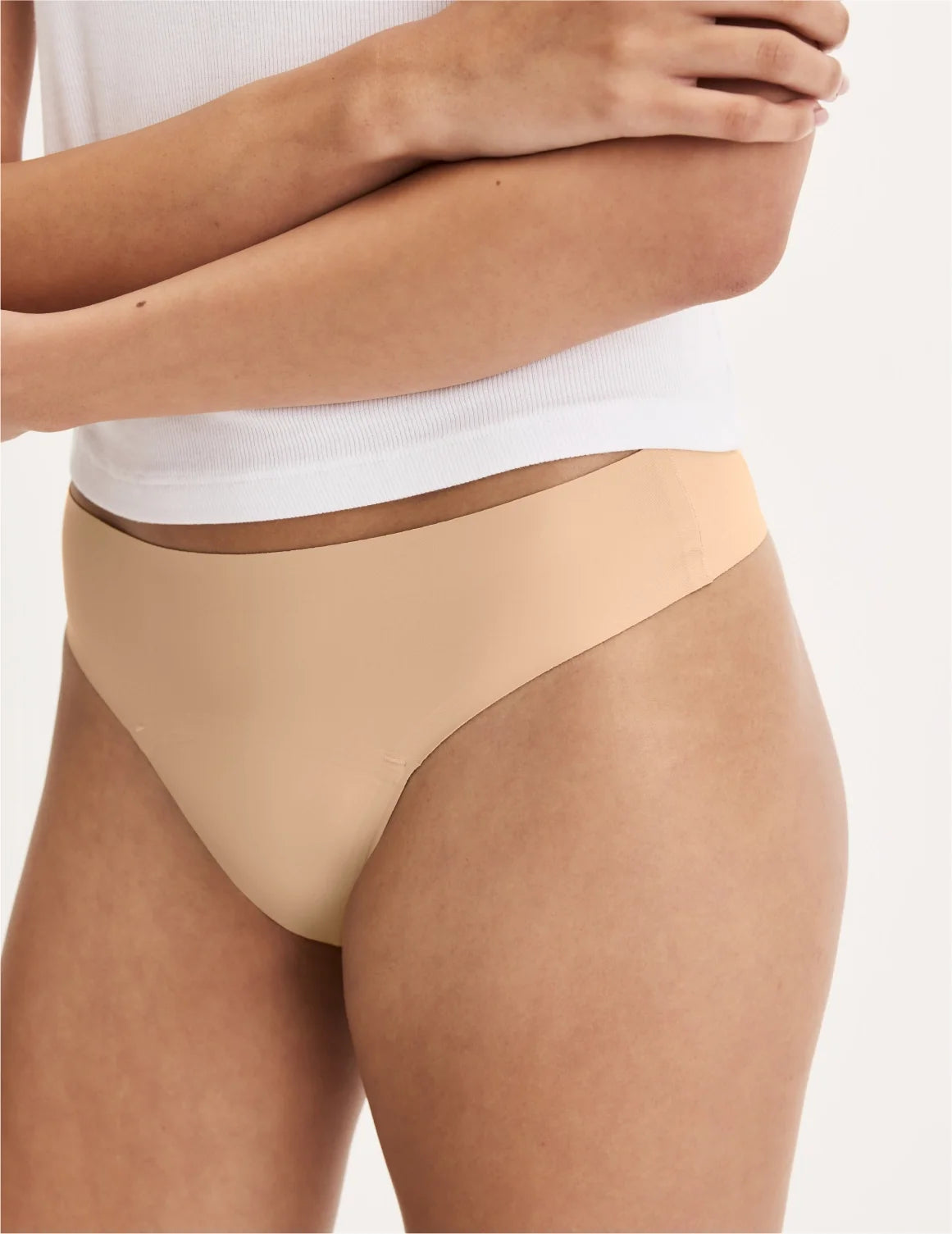 Front view of model wearing the Teen Leakproof UltraThin No-Show Thong highlighting the coverage and smooth fit – Warm Sand – view 5 of 34