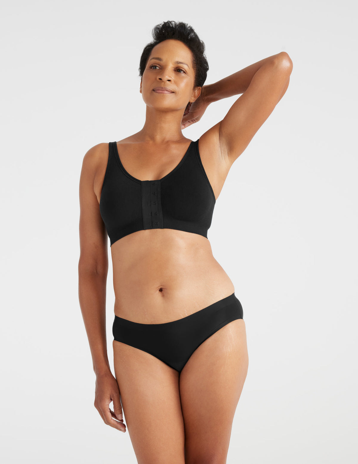 Front view of model wearing the Ultra Soft Front Closure Bra, highlighting the neckline, easy front closure, and seamless knit silhouette – Black – view 9 of 13