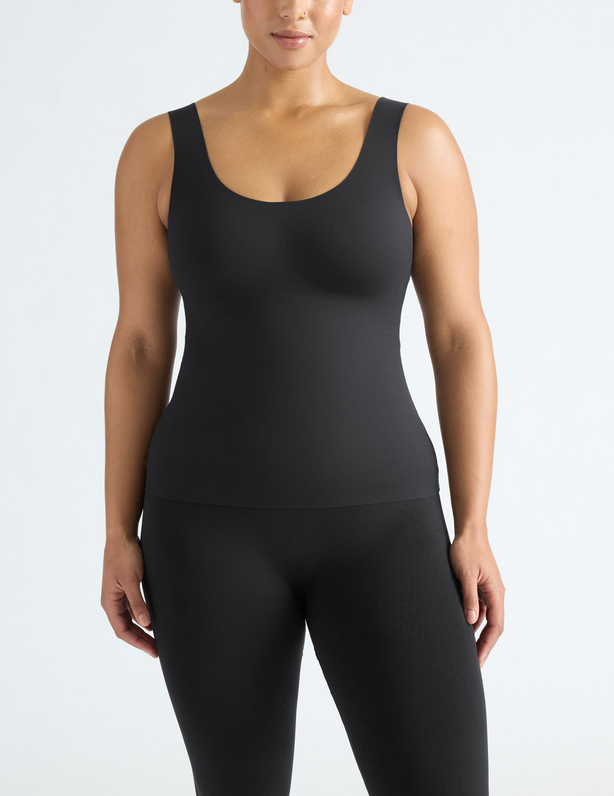 Front view of model wearing the LuxeLift Scoop Neck Tank, highlighting the neckline, strap design, and silhouette – Black – view 3 of 20