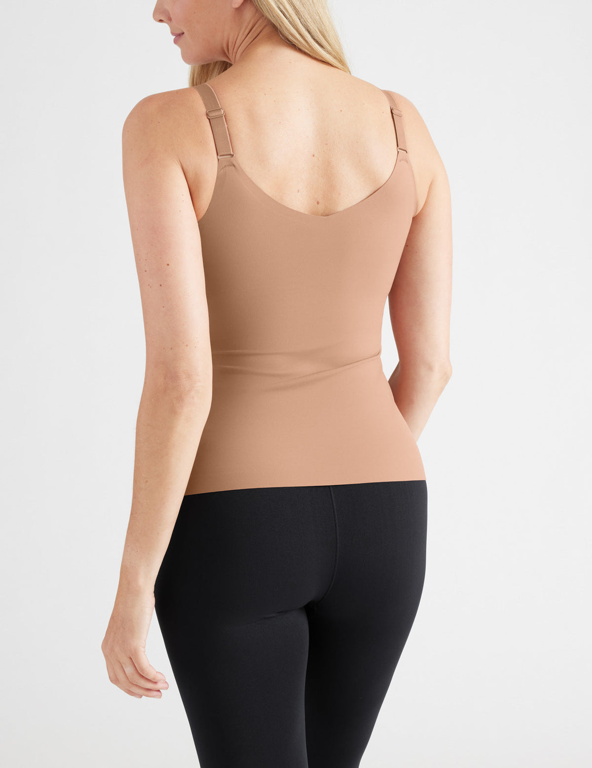 Back view of model wearing the LuxeLift V-Neck Tank, highlighting the neckline, strap design, and silhouette – Cavassa – view 10 of 20