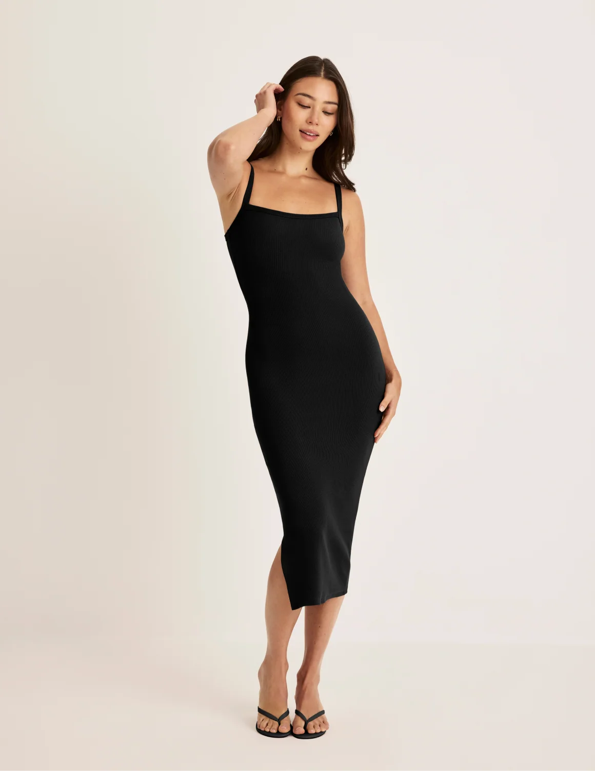 Front view of model wearing the SculptRib™ Cotton Cami Dress highlighting the neckline, fabric and hugging fit – Black – view 6 of 18