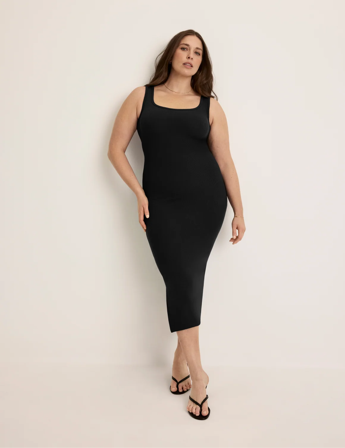 Front view of model wearing the SculptRib™ Cotton Tank Dress highlighting the neckline, hemline and hugging fit – Black – view 1 of 19