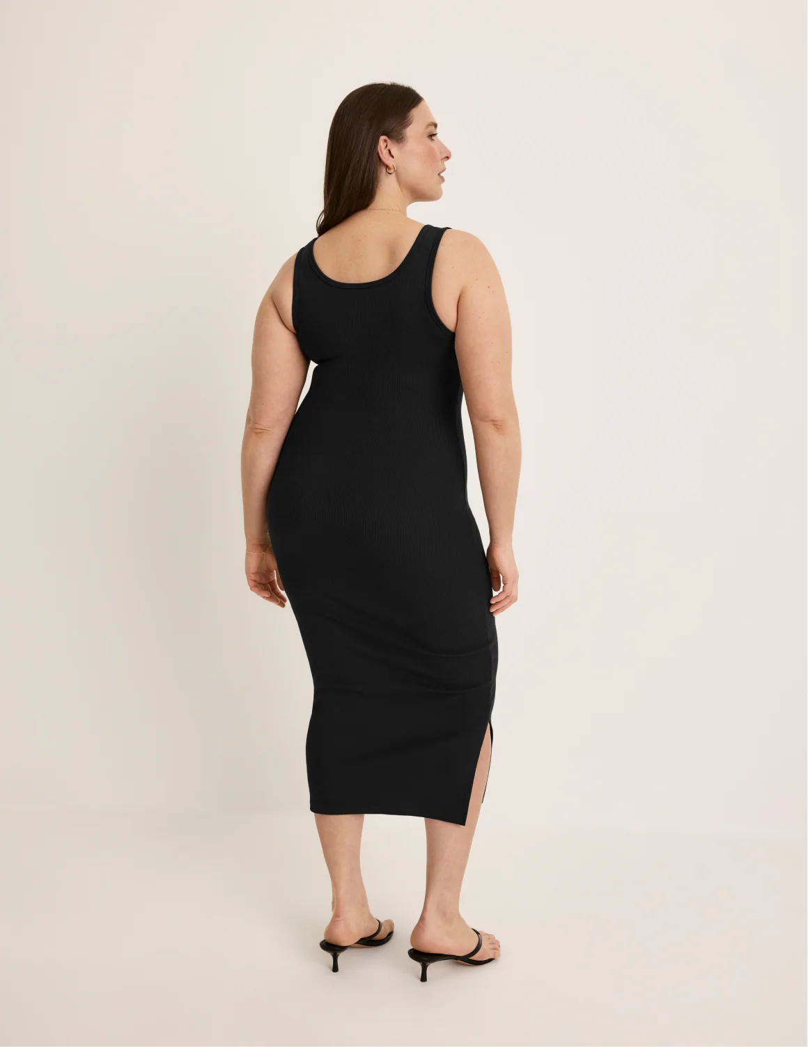 Back view of model wearing the SculptRib™ Cotton Tank Dress highlighting the neckline, hemline and hugging fit – Black – view 3 of 19