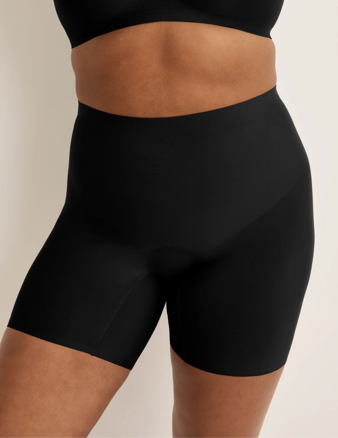 Front view of model wearing the Leakproof Contour Thigh Saver® 6”, highlighting the coverage and smooth fit – Black – view 3 of 19
