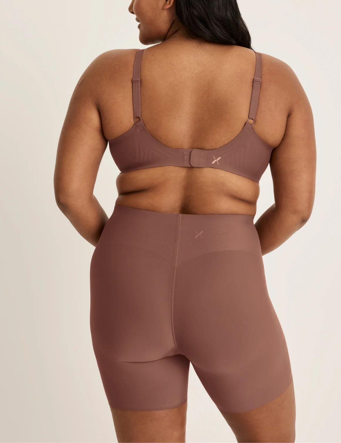 Back view of model wearing the Leakproof Contour Thigh Saver® 6”, highlighting the coverage and smooth fit – Sola – view 10 of 19