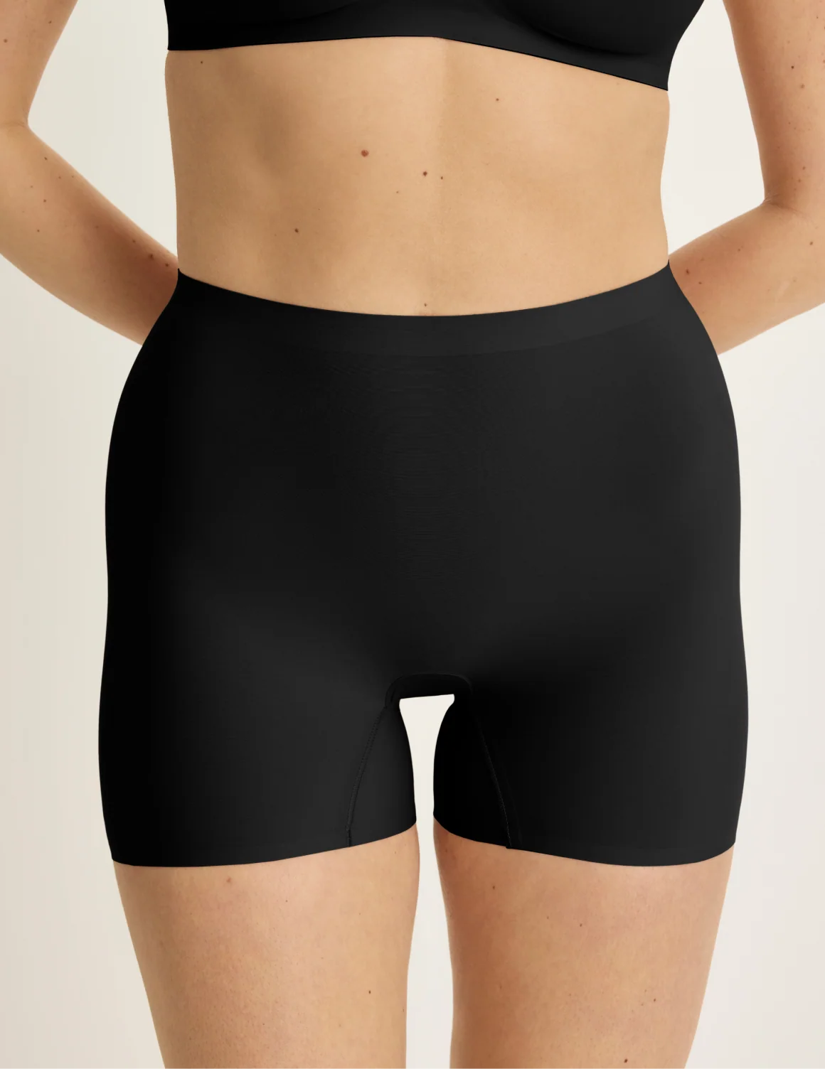 Front view of model wearing the Shortie Thigh Saver® 4”, highlighting the coverage and smooth fit – Black – view 1 of 25