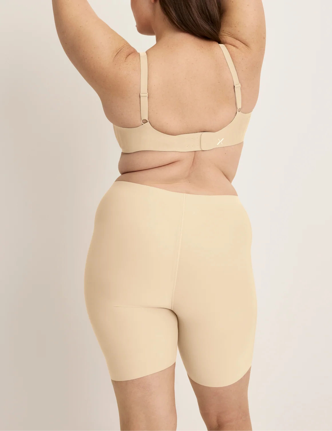 Back view of model wearing the Thigh Saver® 6” highlighting the coverage and smooth fit – Dune – view 9 of 33