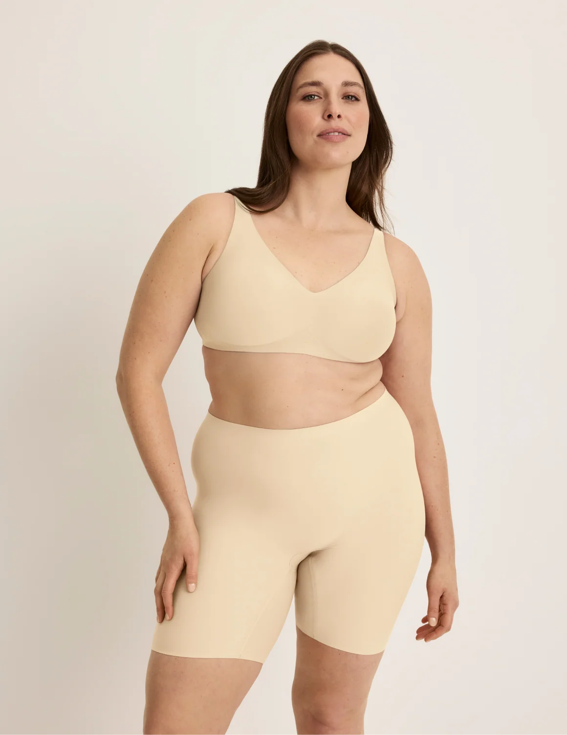 Full-body view of model wearing the Thigh Saver® 6” highlighting the coverage and smooth fit – Dune – view 10 of 33