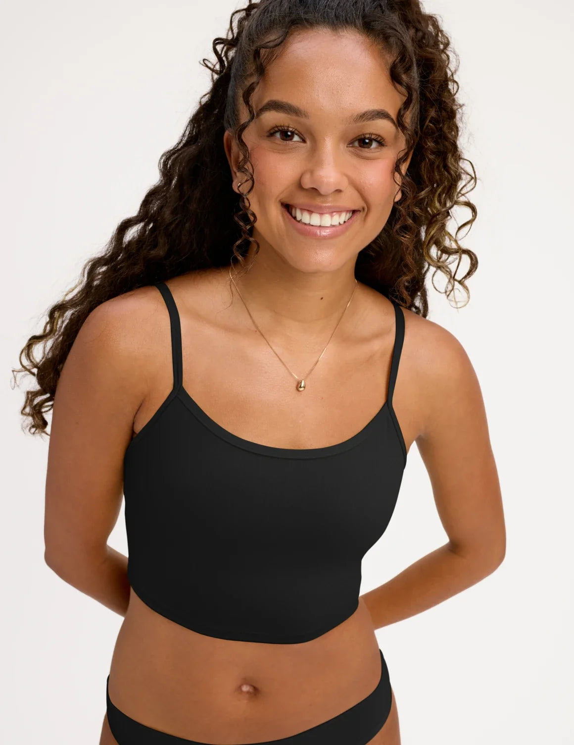 Front view of model wearing the Teen Scoop Tankini Top highlighting the coverage and fit – Black – view 1 of 16