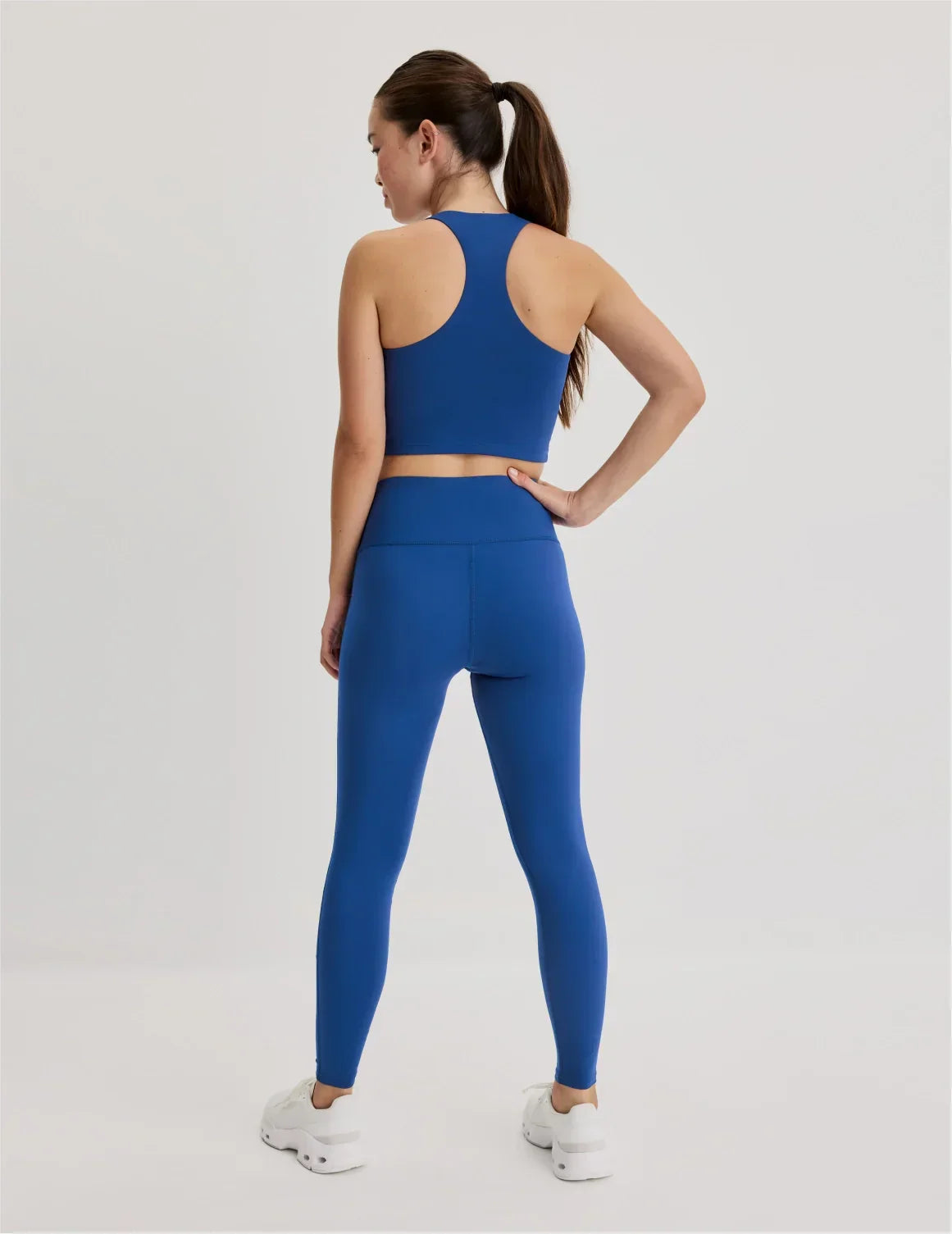Back view of model wearing the Teen Leakproof Active Legging highlighting the coverage and fit – Shady Blue – view 2 of 12
