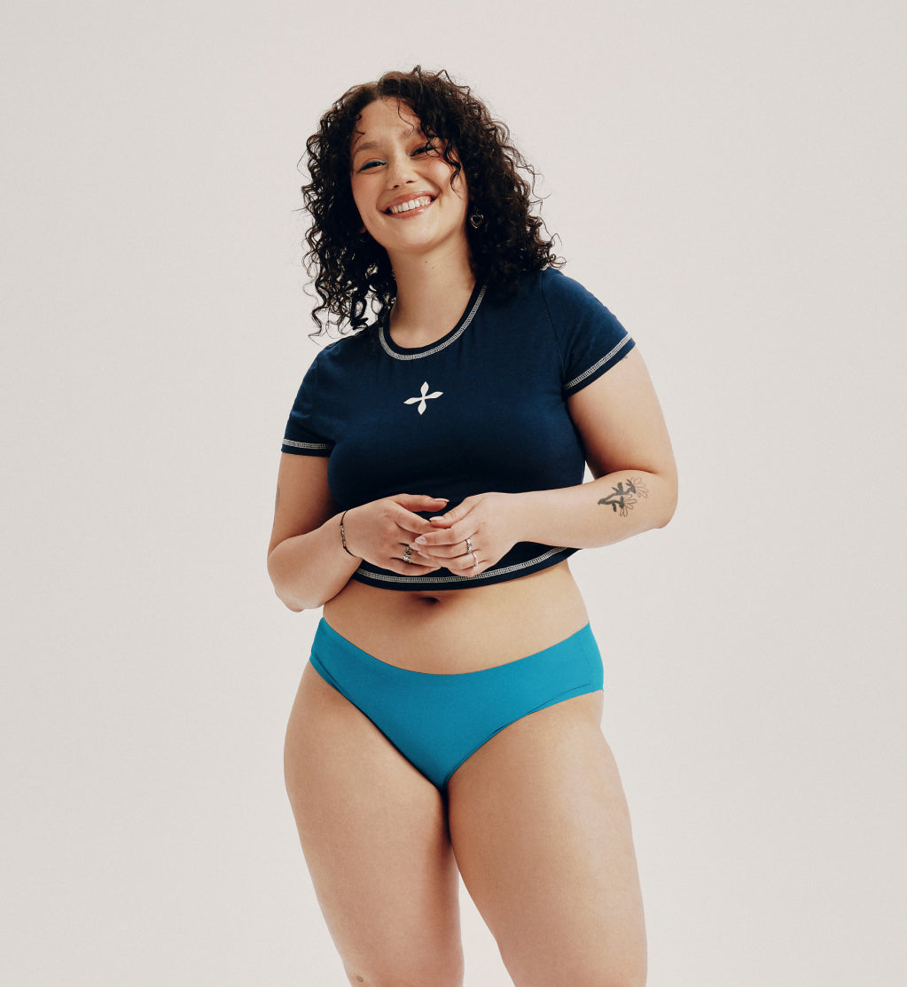 Front view of model wearing the Teen Light Leakproof No-Show Bikini highlighting the coverage and smooth fit – Poolside – view 7 of 67
