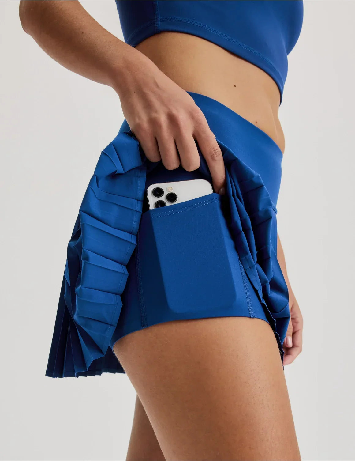 Front view of model wearing the Teen First Serve Pleated Skort highlighting the coverage and fit – Shady Blue – view 8 of 11