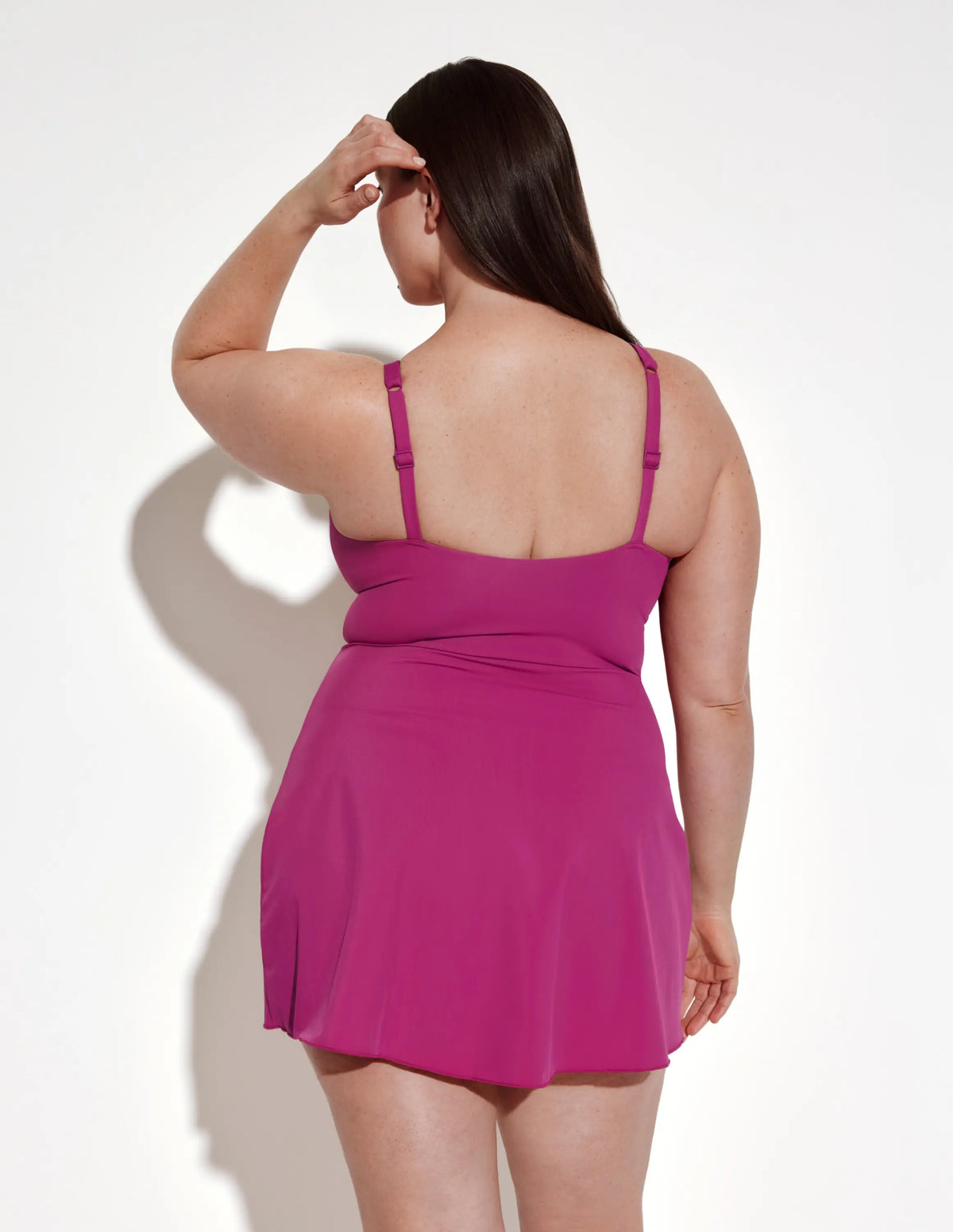 Back view of model wearing the Leakproof Sculpt Deep V Swim Dress highlighting the coverage and fit – Deep Orchid – view 6 of 12