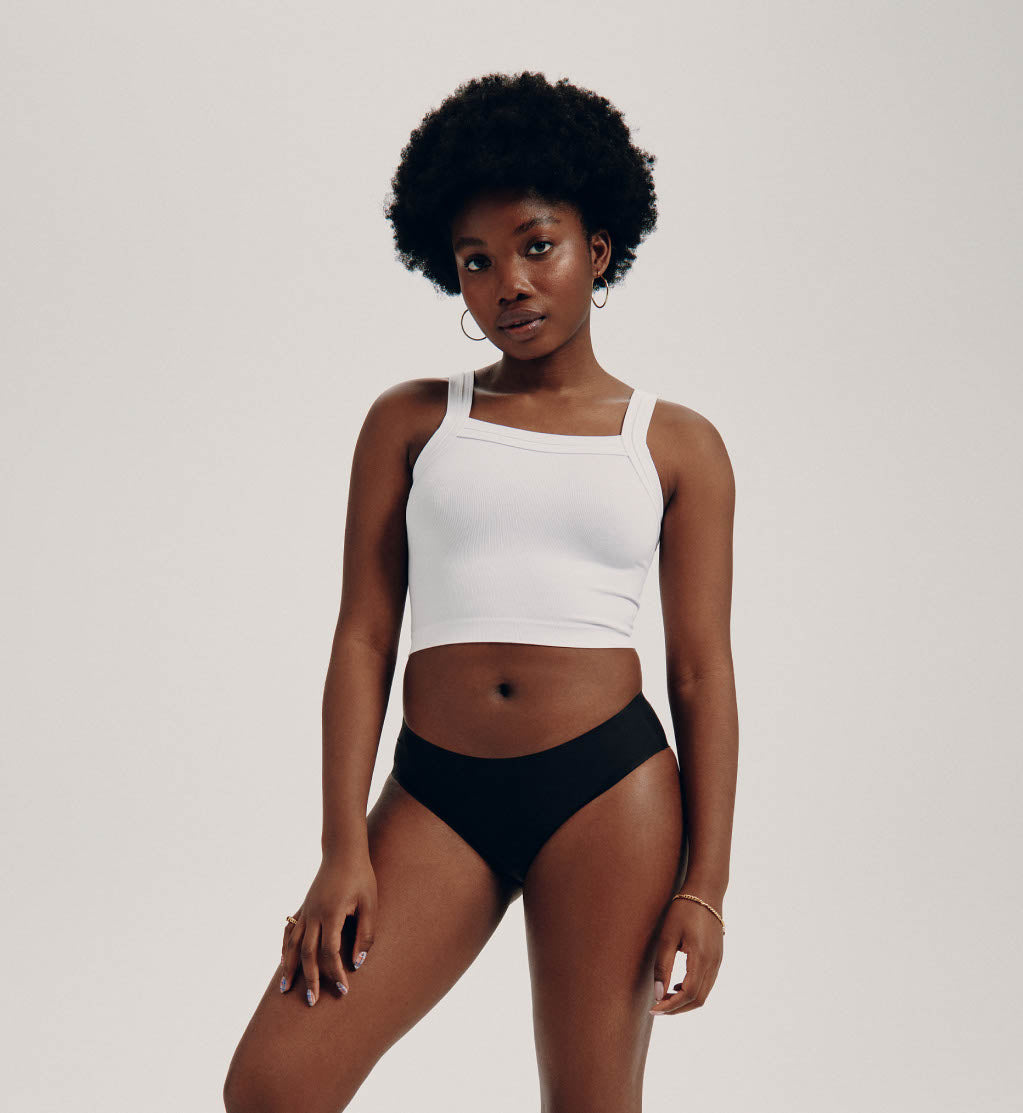 Front view of model wearing the Teen Light Leakproof No-Show Bikini highlighting the coverage and smooth fit – Black – view 4 of 28