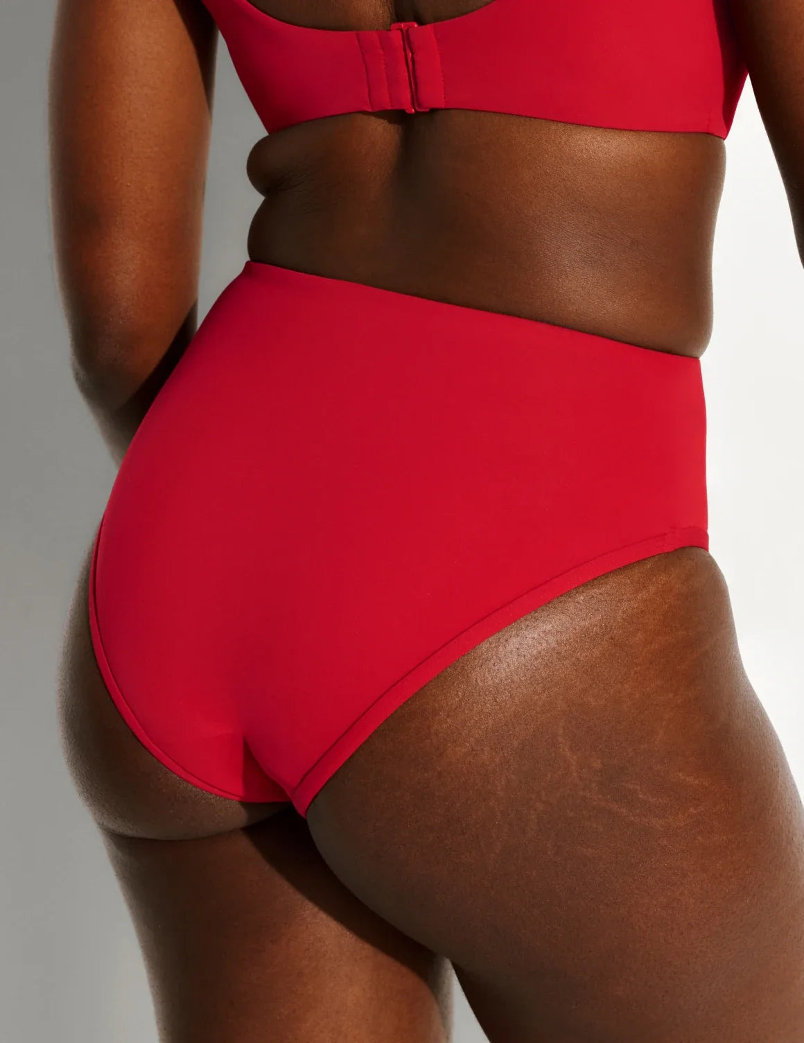 Back view of model wearing the Leakproof Sculpt High Rise Bikini Swim Bottom highlighting the coverage and fit – Cherry – view 9 of 21