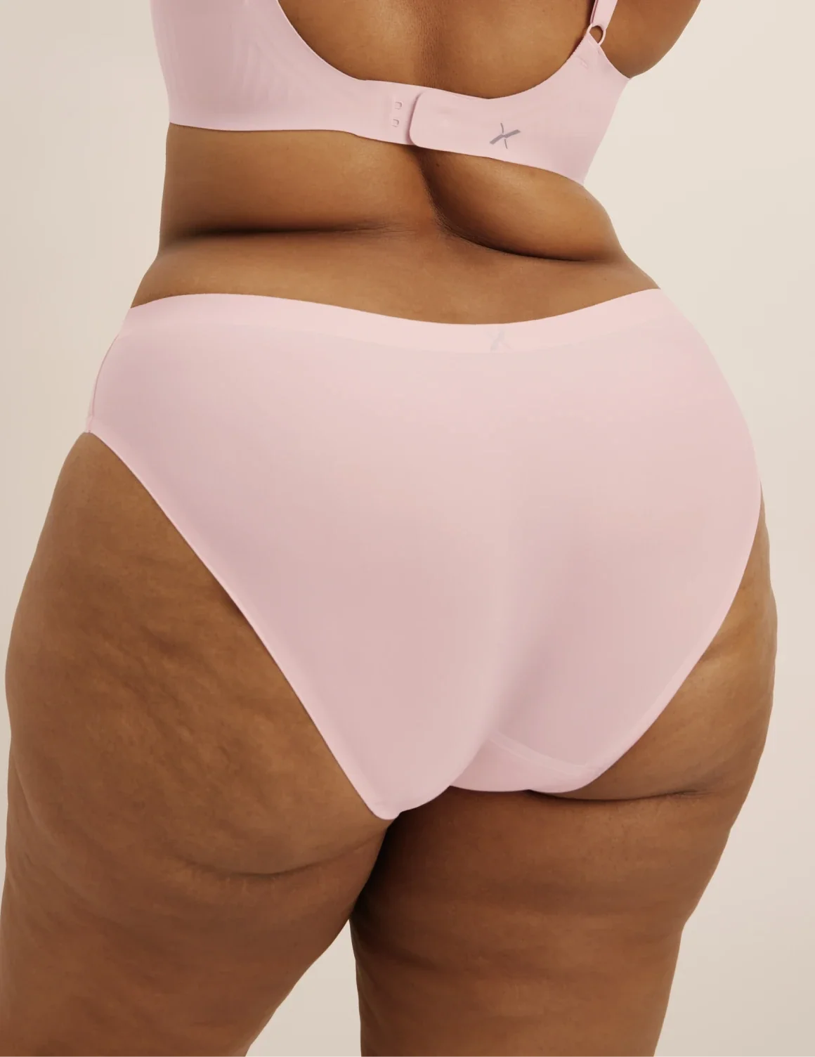 Back view of model wearing the Leakproof UltraThin No-Show Bikini highlighting the coverage and smooth fit – Rose Water – view 12 of 47