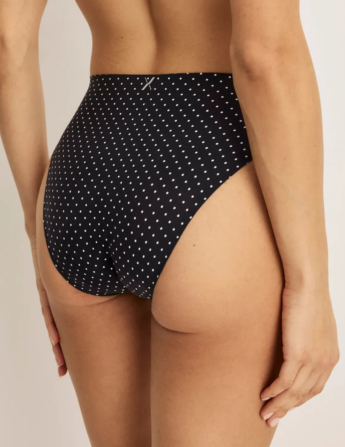 Side view of model wearing the Leakproof UltraThin No-Show French Cut highlighting the coverage and smooth fit – Black with White Polka Dot – view 6 of 36