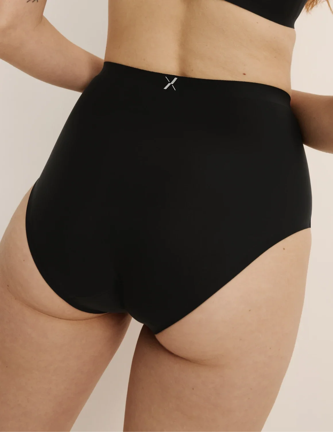 Back view of model wearing the Leakproof UltraThin No-Show High Rise highlighting the coverage and smooth fit – Black – view 6 of 40
