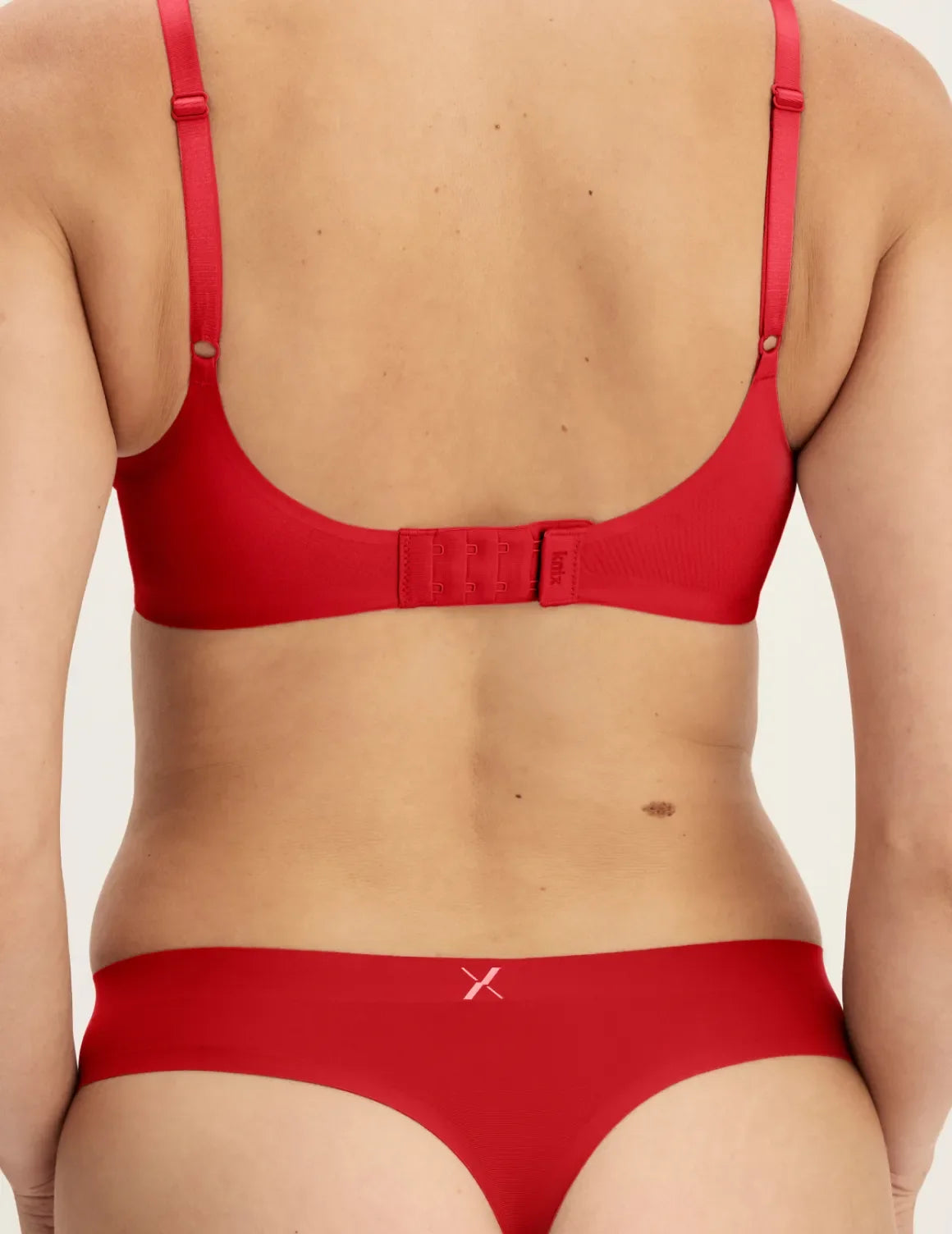 Back view of model wearing the Light Leakproof UltraThin No-Show Thong highlighting the coverage and smooth fit – Shimmer Cherry – view 7 of 40