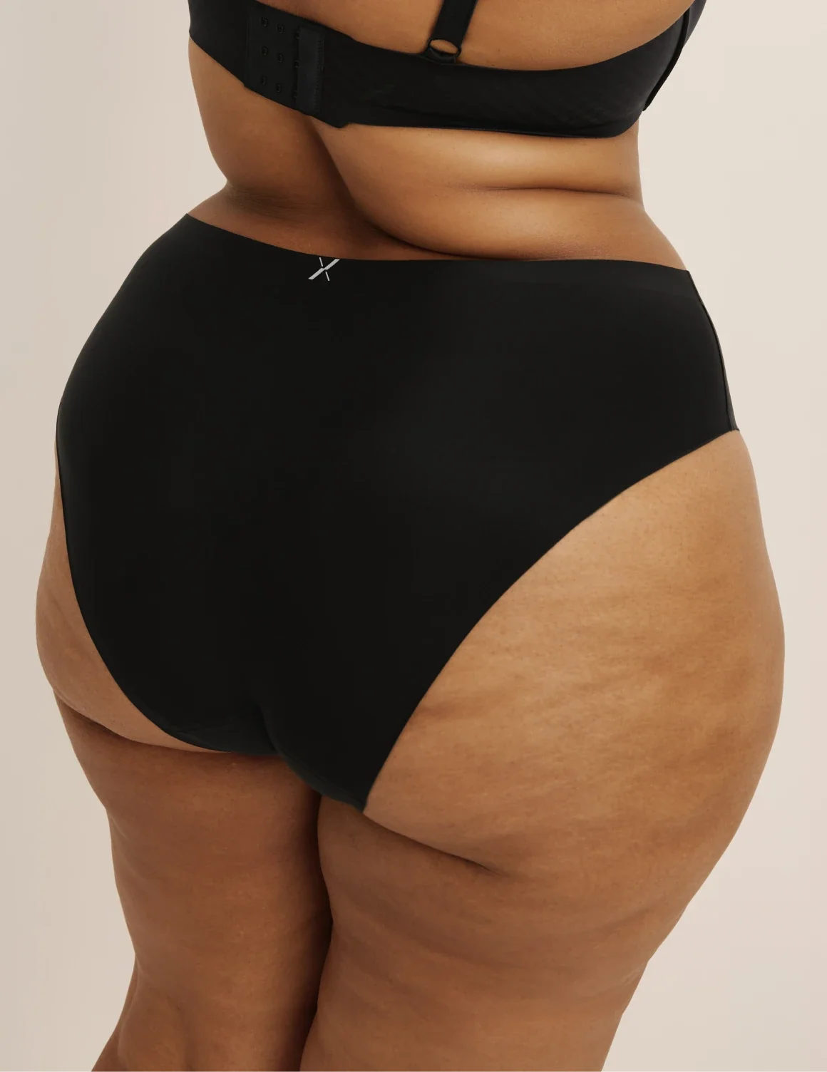 Back view of model wearing the Light Leakproof No-Show French Cut highlighting the coverage and smooth fit – Black – view 3 of 8