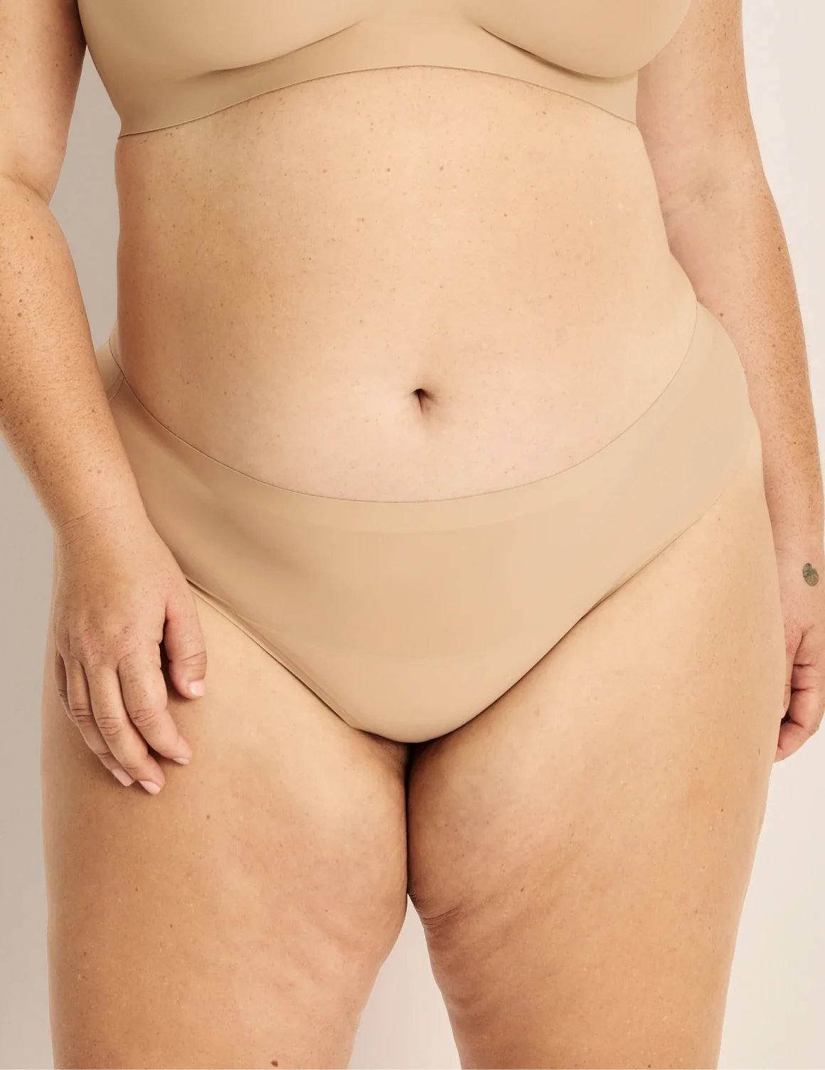 Front view of model wearing the Light Leakproof No-Show Thong highlighting the coverage and smooth fit – Warm Sand – view 5 of 9