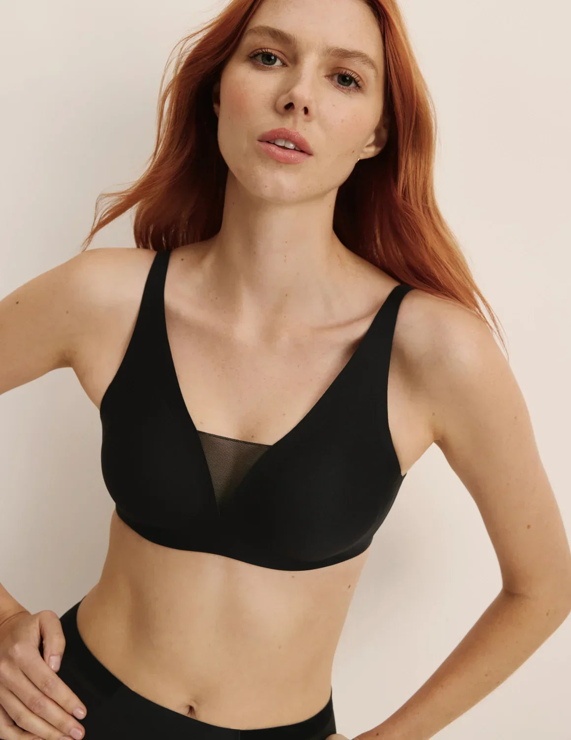 Front view of model wearing the Revolution Shadow Mesh Bra, highlighting the neckline, strap design, and silhouette – Black – view 6 of 19