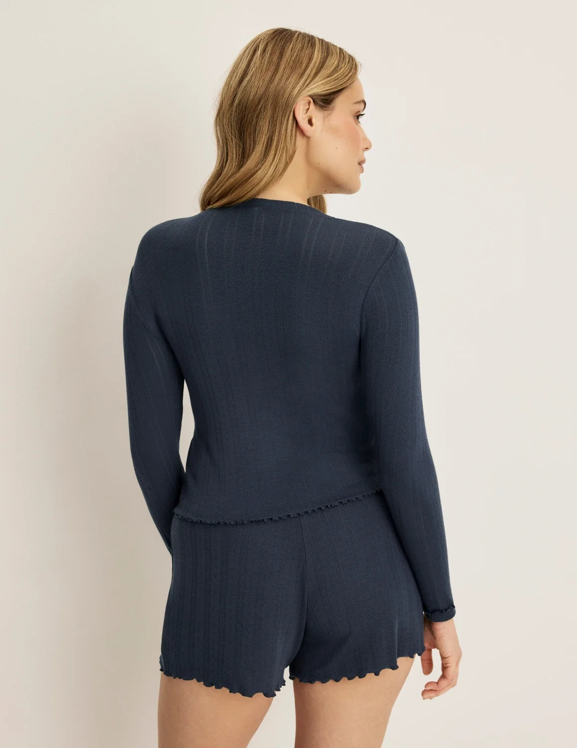 Back view of model wearing the Pointelle Cardigan highlighting the coverage and fit – Twilight Navy – view 3 of 19