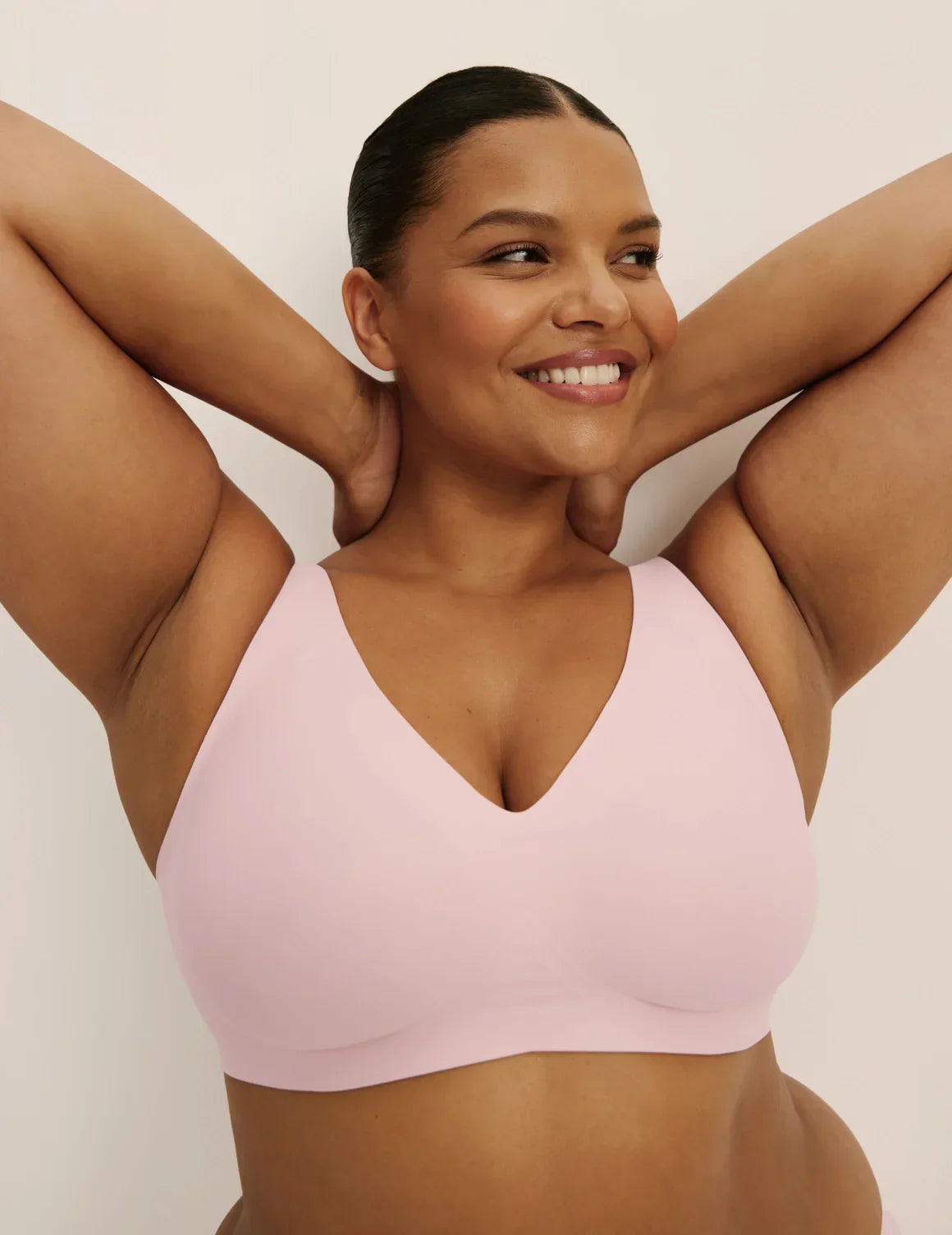 Front view of model wearing the Revolution V-Neck Bra, highlighting the neckline, strap design, and smooth silhouette – Rose Water – view 5 of 50