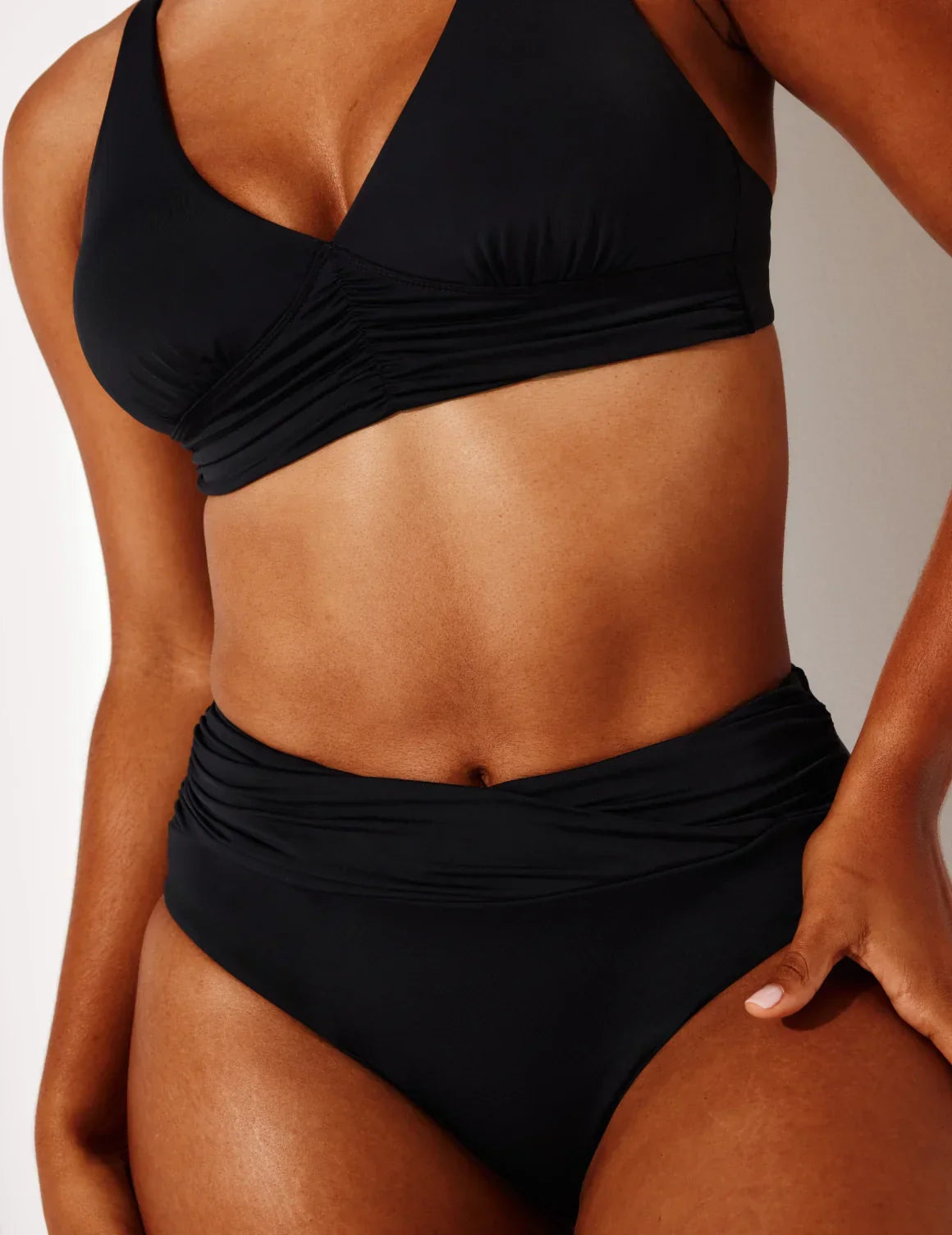 Front view of model wearing the Sculpt Ruched Bikini Swim Bottom highlighting the coverage and fit – Black – view 9 of 14