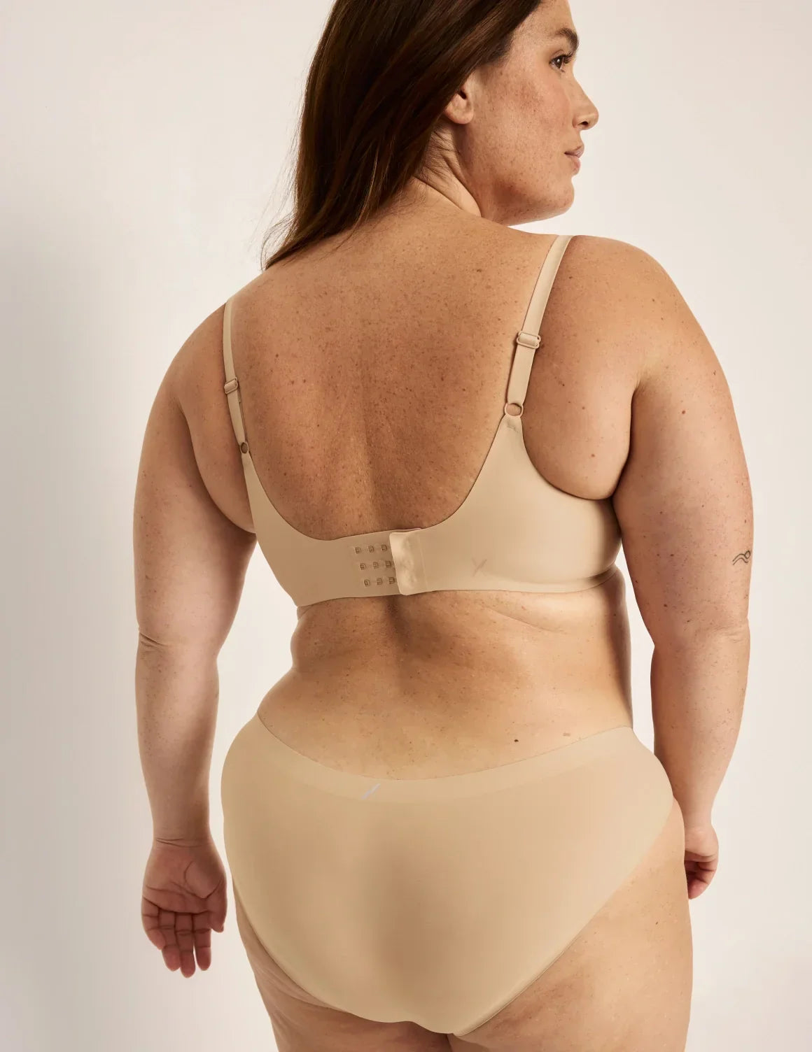 Back view of model wearing the Revolution Shadow Mesh Bra, highlighting the neckline, strap design, and silhouette – Warm Sand – view 4 of 19