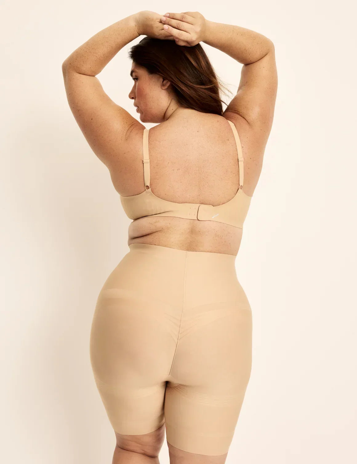 Back view of model wearing the Customizable Shaper High Rise Leakproof Shorts, highlighting the coverage and smooth fit – Warm Sand – view 9 of 18