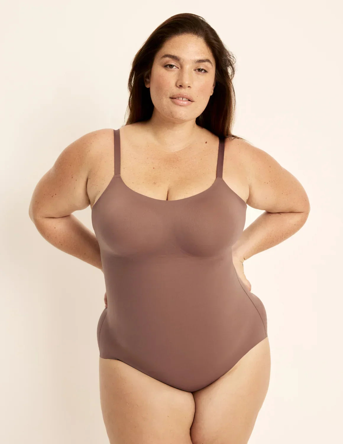 Front view of model wearing the Customizable Shaper Bodysuit highlighting the coverage and smooth fit – Sola – view 2 of 13