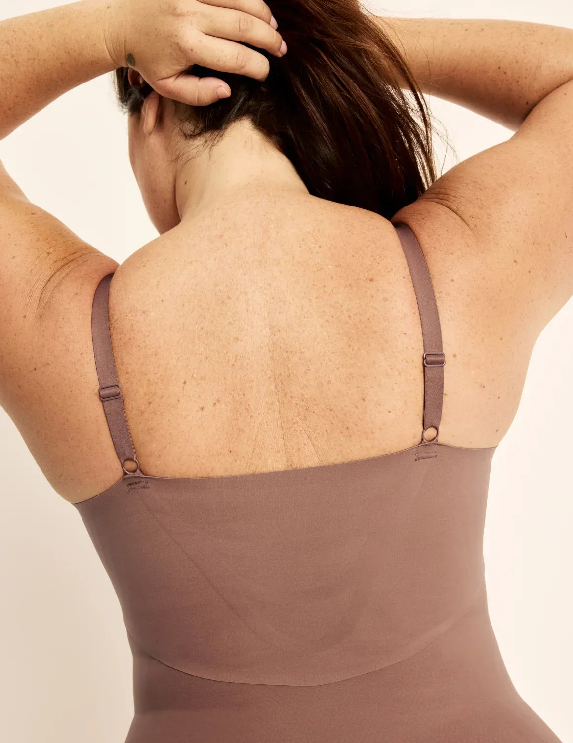 Back view of model wearing the Customizable Shaper Bodysuit highlighting the coverage and smooth fit – Sola – view 11 of 13