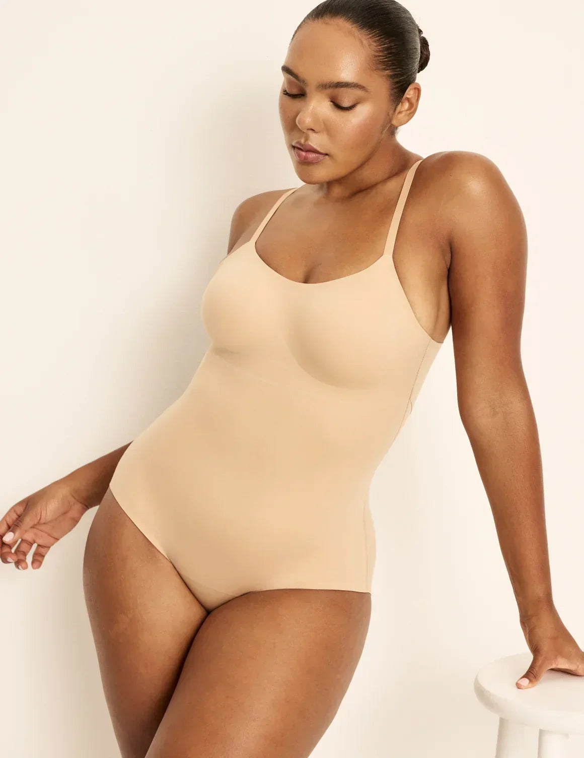 Front view of model wearing the Customizable Shaper Bodysuit highlighting the coverage and smooth fit – Warm Sand – view 3 of 13